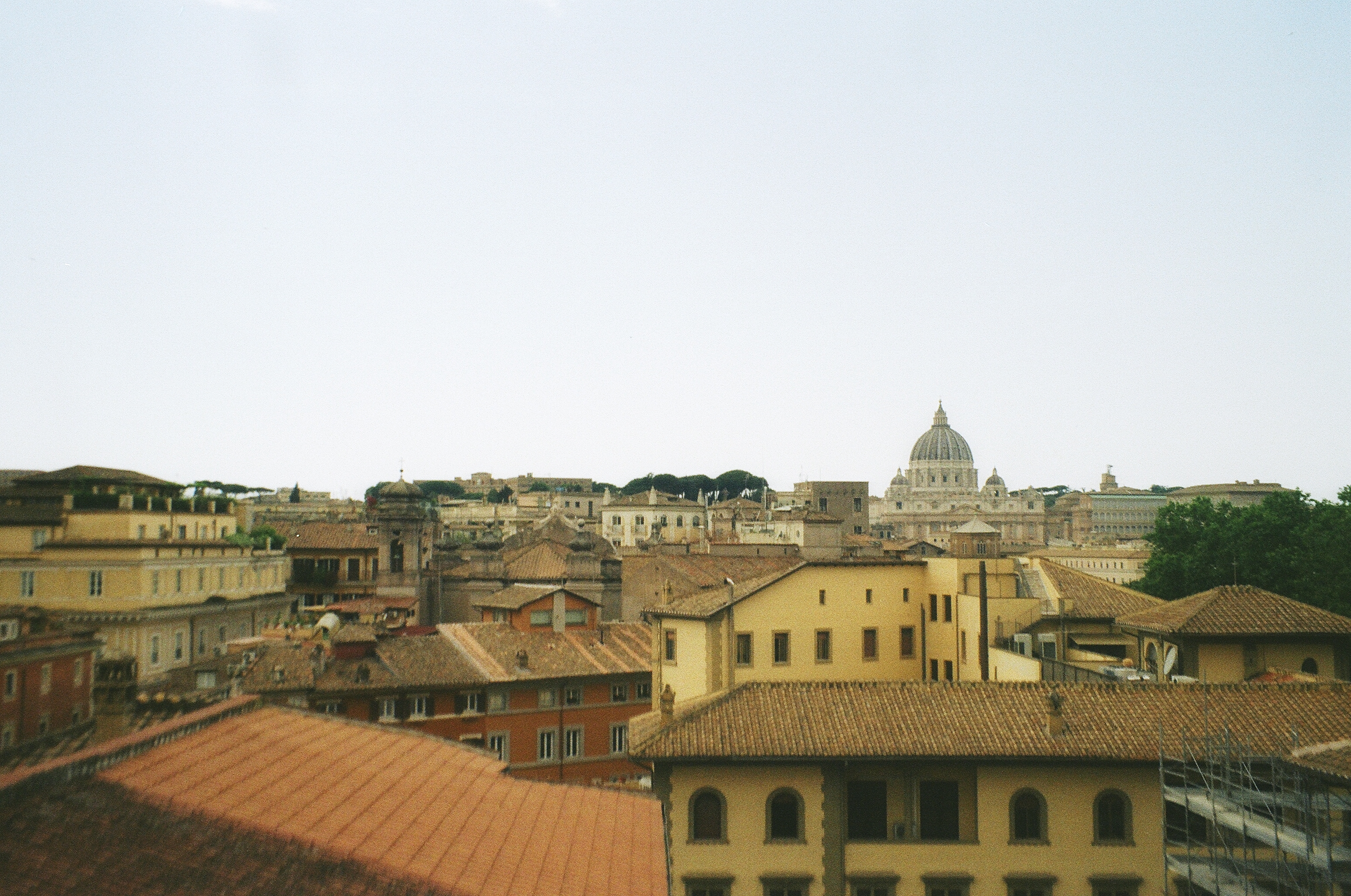 This image depicts the many different rooftops in Rome Italy. In the distance you can see the famous St.Peter's Basillica in Vatican City 